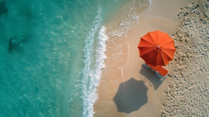 sun bed and a sun shade umbrella on the sandy beach by the ocean, drone, from above