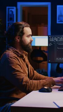 Programmer developing code on computer screen while in personal office using java programming languages. IT admin working with software tool, fixing database errors while working from home, camera B