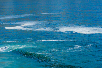 Two tiny surfers cresting an Atlantic Ocean wave along Clarence Drive between Gordon's Bay and Rooi-Els near Cape Town, Western Cape. South Africa