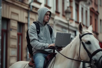 Fotobehang Urban Cowboy Typing on Laptop While Riding Horse in the City Streets. Concept of fight against terrorism or anti-terrorism © zakiroff
