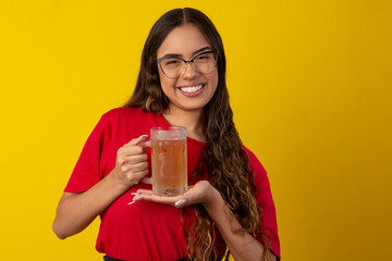 woman with long curly hair wearing glasses and holding glass of cold beer