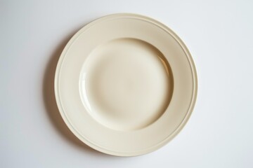 Obraz na płótnie Canvas A white plate sitting on top of a white table. Perfect for food photography or minimalist design