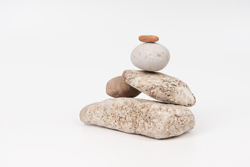 pyramid of different sea stones on a white background