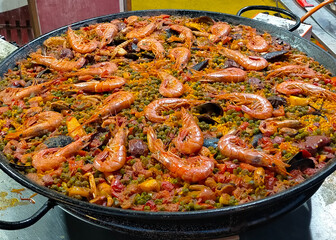 large Valencian paella in closeup outdoors with sunlight