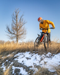 senior male cyclist on a mountain bike, winter scenery in Fort Collins, Colorado