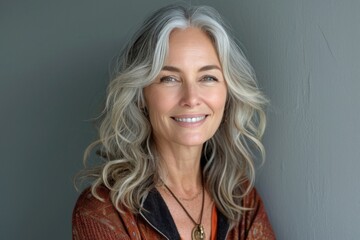 Portrait of happy 50 year old woman with long gray hair
