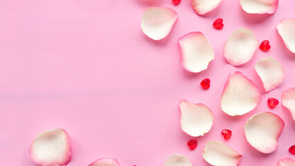 White rose petals on pastel pink background. Valentine or wedding abstract background. Copy space...