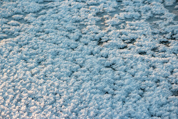 The frozen surface of a reservoir covered with grown crystalline hoarfrost