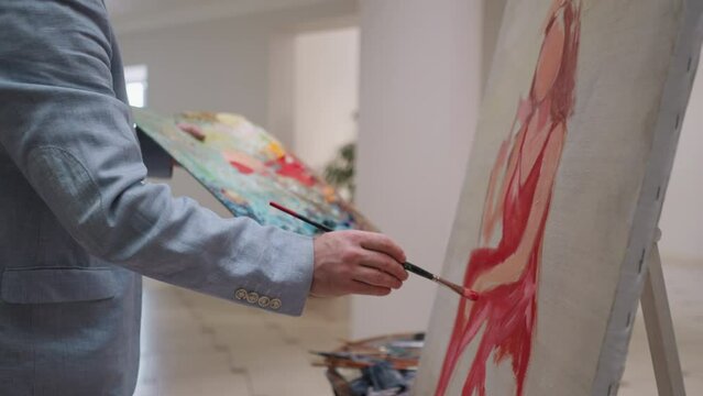Man draws woman of dreams in studio