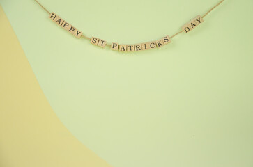 wooden letters with the inscription st. patrick's day hung on a rope