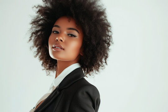 A young African American woman charismatically and elegantly dressed in a sophisticated and attractive feminine suit
