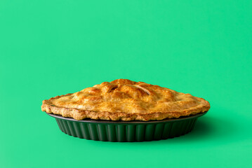 Apple pie close up, minimalist on a green background