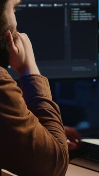 Computer engineer deliberating ways of fixing errors while developing code on PC. IT professional brainstorming ways of solving database errors, remotely working from home, camera A