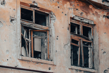empty windows of a damaged house in Ukraine