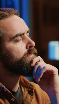 Software engineer puzzled in front of computer screen while writing complex code. Admin feeling confused while trying to fix database errors while working from home, camera A close up