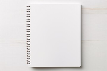 a white notebook with a spiral bound on a white surface - obrazy, fototapety, plakaty
