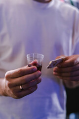 person holding a communion bread and wine