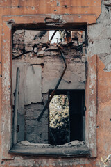 empty window of a destroyed house in Ukraine