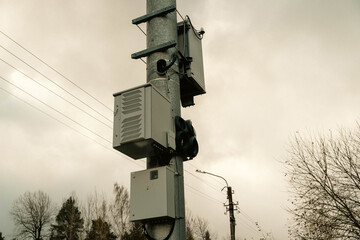high-voltage transformer or a cell tower distribution box located high on a pole