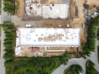 the construction site of an apartment building in the summer from a height