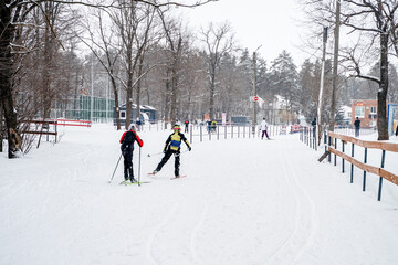 Skiers on skis in a pine snowy winter forest. Amateur simple skiing. Samara, Russia - 3 Jan 2024