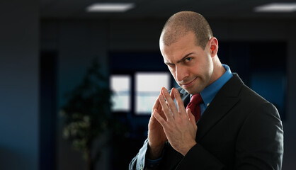 A smirking man in a suit with a conniving expression in a corpor