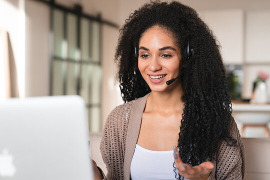 Remote worker seller, hotline agent, customer support manager. Tutor having e-lesson e-learning online from laptop wearing headset. Web conference, videocall