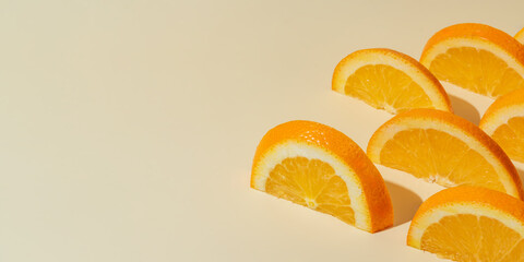 Fruit pattern of orange slices on beige background with copy space. Banner
