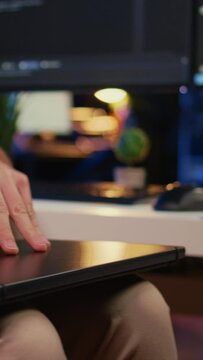 Remote programmer starting job shift in personal office at home, taking laptop out of bag. Teleworker unpacking backpack, writing lines of code on notebook keyboard, camera B close up