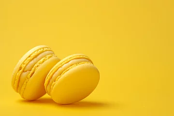 Foto op Canvas two yellow macaroons on yellow background in the styl © sdstudio