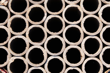 Pattern of old, hollow cardboard tubes, visible wear.