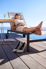 Relax, pool and woman in chair with champagne, brunch and business trip with hotel service. Travel,...