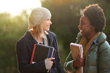 College, books and conversation with woman friends outdoor on campus together for learning or...