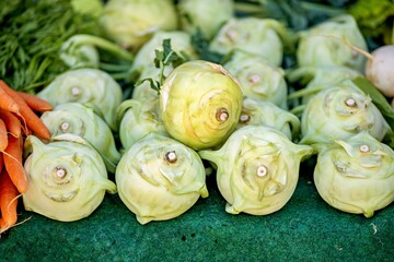Bunch of artichokes sitting on top of green table.