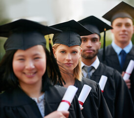 Portrait, graduation and woman in line with friends at college or university for ceremony of achievement. Education, certificate and scholarship with group of young graduate people outdoor on campus