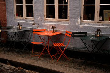 orange table and chairs in the streets of copenhagen