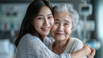 Elderly asian sick woman embracing her adult daughter in a hospital
