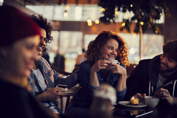 Diverse group of young people sitting in a cafe