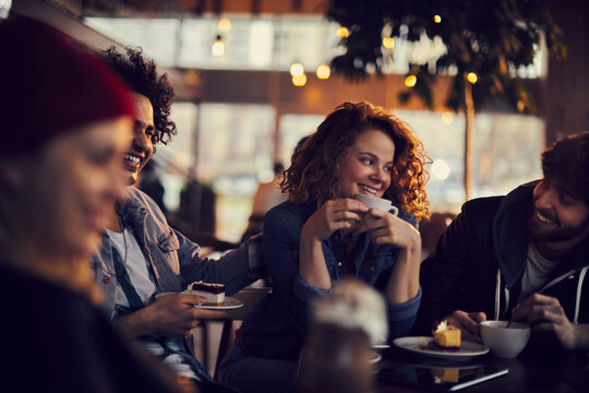 Diverse group of young people sitting in a cafe