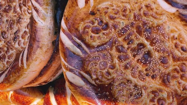 Tortillas on the market in Samarkand, Uzbekistan - June 29, 2023: Goods and traders at the Oriental Bazaar in Uzbekistan. Siab Bazaar is the largest and oldest bazaar in Samarkand. 4K