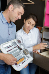 smiling shop assistant working with customer in store