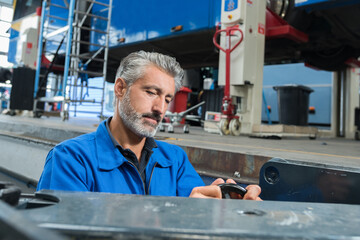 attractive mechanic wearing overalls working alone