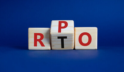 RPO vs RTO symbol. Wooden cubes with words RTO to RPO. Beautiful deep blue background. business concept. Copy space