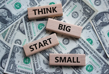 Think big start small symbol. Concept words Think big start small on wooden blocks. Beautiful...