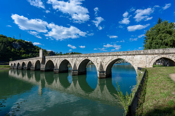 Fototapeta premium Visegrad, Bosnia and Herzegovina - August 13, 2023: Famous bridge on the Drina in Visegrad, Bosnia and Herzegovina. Mehmed Pasa Sokolovic Bridge on Drina River