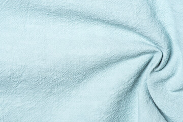 Background of light blue fabric with folds, textured background