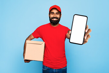 Indian male courier with package and smartphone on blue
