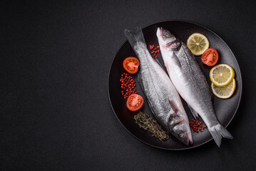 Fresh raw ocean sea bass fish with salt, spices and herbs