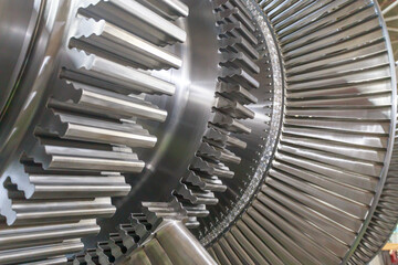 Important parts of steam turbine rotor at processing line in a factory workshop.