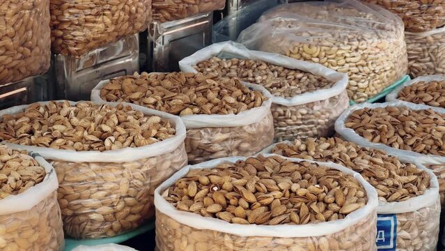 Dried Fruits, nuts and Spices market in Samarkand, Uzbekistan - June 29, 2023: Goods and traders at the Oriental Bazaar in Uzbekistan. Siab Bazaar is the largest and oldest bazaar in Samarkand. 4K